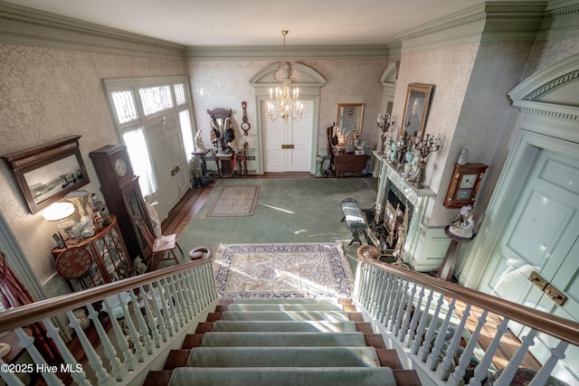 900 Nash St N, Wilson, NC 27893 - entrance foyer featuring a chandelier, stairway, a premium fireplace, crown molding, and wallpapered walls