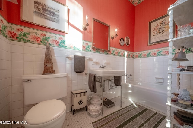900 Nash St N, Wilson, NC 27893 - full bathroom featuring wallpapered walls, tile walls, wainscoting, tile patterned flooring, and a garden tub