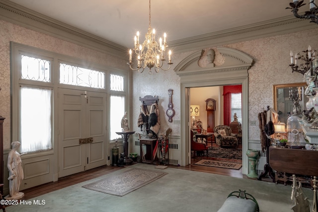 900 Nash St N, Wilson, NC 27893 - entryway featuring wood finished floors, wallpapered walls, a chandelier, and crown molding