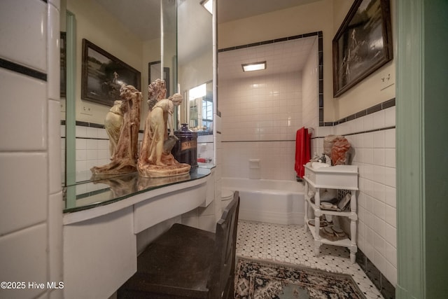 900 Nash St N, Wilson, NC 27893 - bathroom featuring tile walls and a tub to relax in
