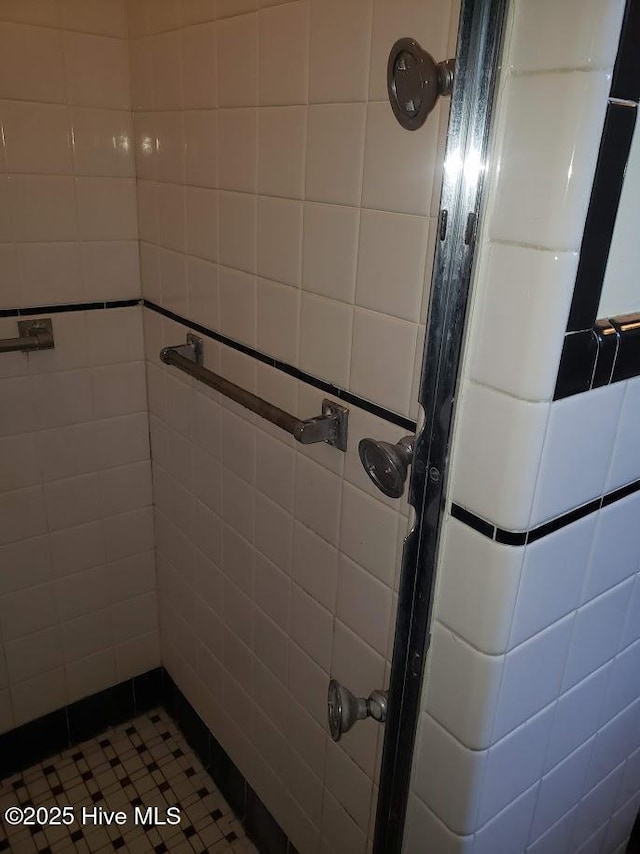 900 Nash St N, Wilson, NC 27893 - bathroom featuring a shower stall, tile walls, and tile patterned flooring