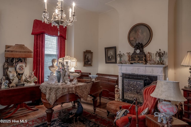 900 Nash St N, Wilson, NC 27893 - sitting room featuring wood finished floors, a premium fireplace, a chandelier, and arched walkways