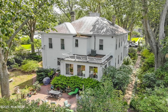900 Nash St N, Wilson, NC 27893 - back of property featuring a chimney, a patio, a balcony, and view of wooded area