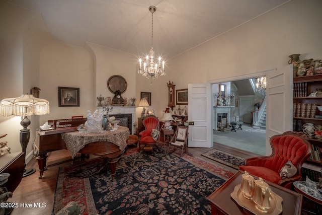 900 Nash St N, Wilson, NC 27893 - living area with a glass covered fireplace, a chandelier, stairs, wood finished floors, and high vaulted ceiling