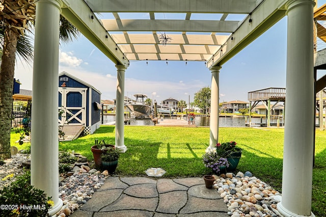 4061 4th St, Surf City, NC 28445 - view of patio / terrace with a storage unit, a water view, and a pergola