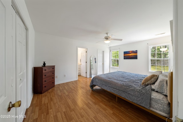 32 S Shelby Rd, Southport, NC 28461 - bedroom with light wood-style floors, ceiling fan, a closet, and ensuite bathroom