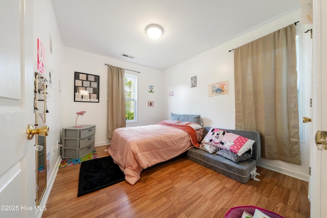 32 S Shelby Rd, Southport, NC 28461 - bedroom featuring light wood-style flooring and baseboards