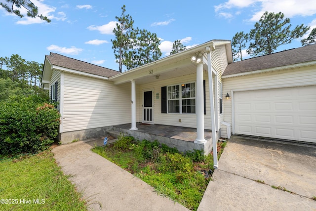32 S Shelby Rd, Southport, NC 28461 - view of front facade with an attached garage, covered porch, and driveway