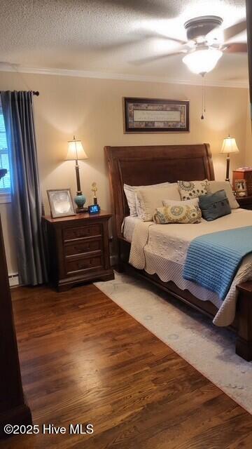 2262 Old Oak Rd, Kinston, NC 28504 - bedroom with crown molding, wood finished floors, a ceiling fan, and a textured ceiling