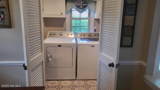 2262 Old Oak Rd, Kinston, NC 28504 - laundry area featuring washing machine and clothes dryer and cabinet space