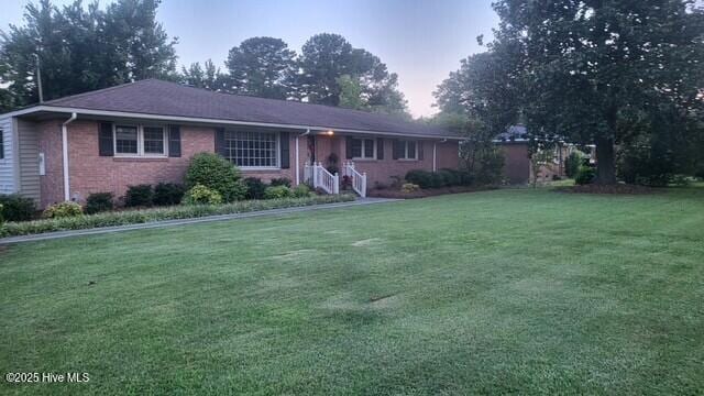 2262 Old Oak Rd, Kinston, NC 28504 - ranch-style home with a front lawn and brick siding