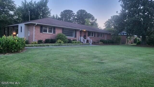 2262 Old Oak Rd, Kinston, NC 28504 - ranch-style house with a lawn and brick siding