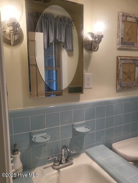 2262 Old Oak Rd, Kinston, NC 28504 - bathroom featuring tile walls and a wainscoted wall
