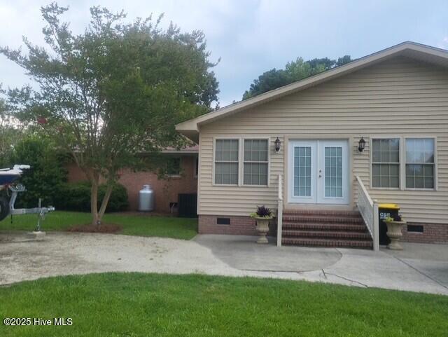 2262 Old Oak Rd, Kinston, NC 28504 - view of front of property with crawl space, french doors, entry steps, a front yard, and a patio area