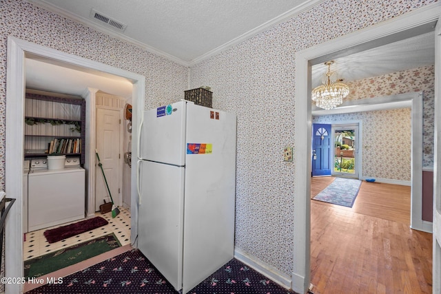 1710 National Ave, New Bern, NC 28560 - kitchen featuring freestanding refrigerator, ornamental molding, wallpapered walls, wood finished floors, and a chandelier