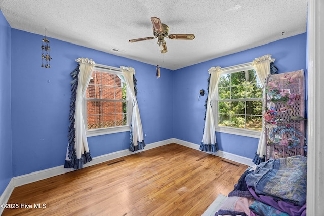 1710 National Ave, New Bern, NC 28560 - unfurnished room featuring wood finished floors, a textured ceiling, and ceiling fan