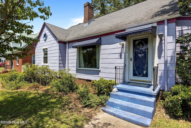 1710 National Ave, New Bern, NC 28560 - view of exterior entry featuring a chimney and a shingled roof