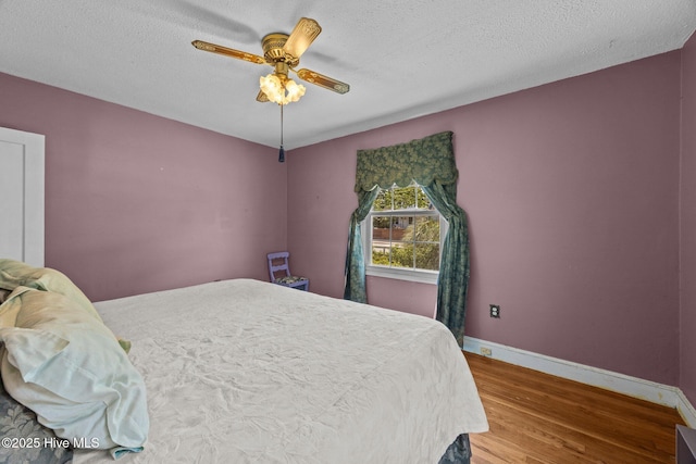 1710 National Ave, New Bern, NC 28560 - bedroom with wood finished floors, a ceiling fan, and a textured ceiling