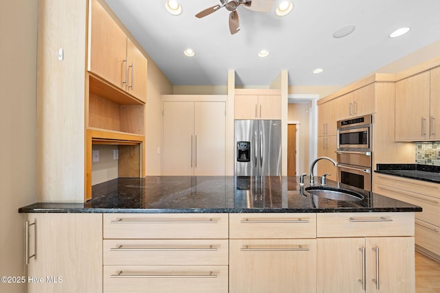 2945 Moorings Way SE, Southport, NC 28461 - kitchen with appliances with stainless steel finishes, light brown cabinets, dark stone countertops, ceiling fan, and a peninsula