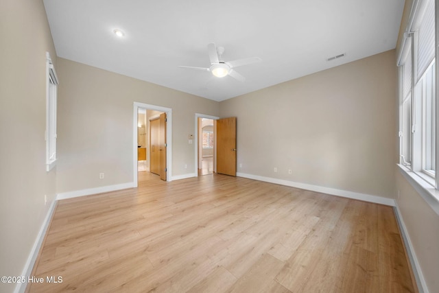 2945 Moorings Way SE, Southport, NC 28461 - unfurnished bedroom with light wood-type flooring, ensuite bath, and a ceiling fan