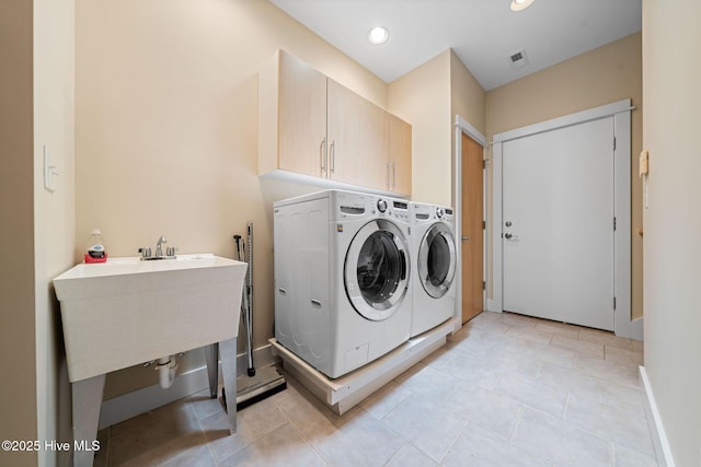 2945 Moorings Way SE, Southport, NC 28461 - washroom featuring cabinet space, separate washer and dryer, light tile patterned floors, and recessed lighting