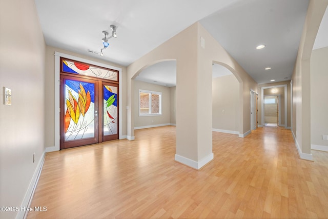2945 Moorings Way SE, Southport, NC 28461 - foyer entrance featuring arched walkways, light wood-style flooring, and recessed lighting
