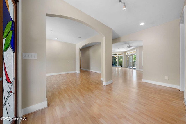 2945 Moorings Way SE, Southport, NC 28461 - empty room featuring arched walkways, ceiling fan, light wood-type flooring, and recessed lighting