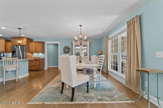 124 Juniper Creek Blvd Unit 16, Pinehurst, NC 28374 - dining room featuring a chandelier, wood finished floors, and recessed lighting