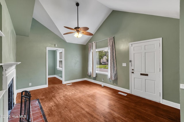 104 W Bayshore Blvd, Jacksonville, NC 28540 - unfurnished living room featuring ceiling fan, wood finished floors, a fireplace, and high vaulted ceiling