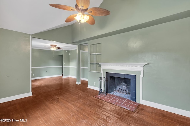 104 W Bayshore Blvd, Jacksonville, NC 28540 - unfurnished living room with a ceiling fan, wood finished floors, a tile fireplace, built in shelves, and high vaulted ceiling