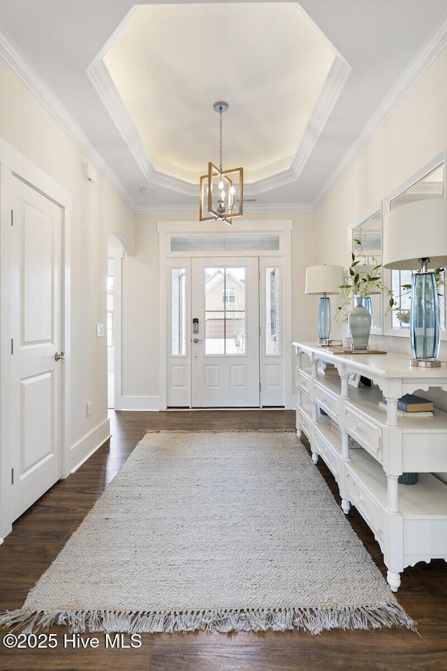 449 Motts Forest Rd Unit 64R, Wilmington, NC 28412 - entryway featuring plenty of natural light, a chandelier, a raised ceiling, dark wood-style flooring, and ornamental molding