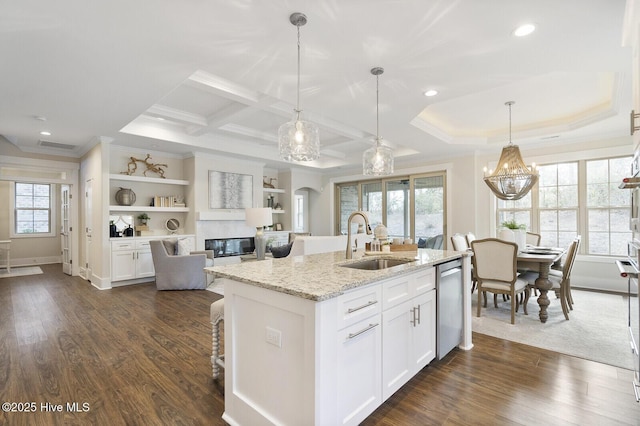 449 Motts Forest Rd Unit 64R, Wilmington, NC 28412 - kitchen with ornamental molding, stainless steel dishwasher, white cabinetry, light stone countertops, and a kitchen island with sink