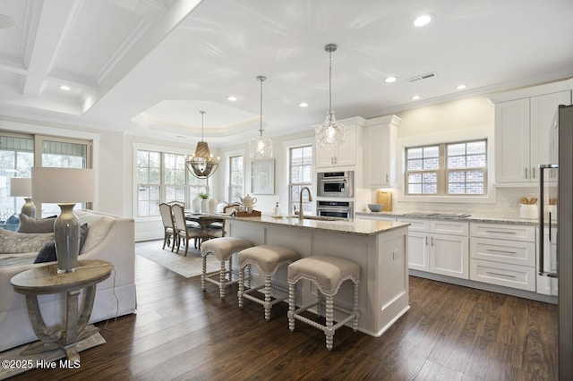 449 Motts Forest Rd Unit 64R, Wilmington, NC 28412 - kitchen with light stone countertops, open floor plan, ornamental molding, a kitchen breakfast bar, and white cabinetry