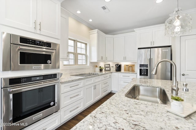 449 Motts Forest Rd Unit 64R, Wilmington, NC 28412 - kitchen featuring appliances with stainless steel finishes, white cabinetry, dark wood-style flooring, recessed lighting, and light stone countertops