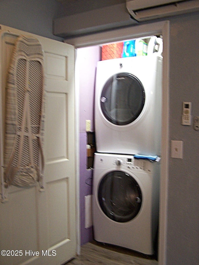 206 Community Rd, Eagle Springs, NC 27242 - laundry area featuring stacked washer / drying machine and wood finished floors