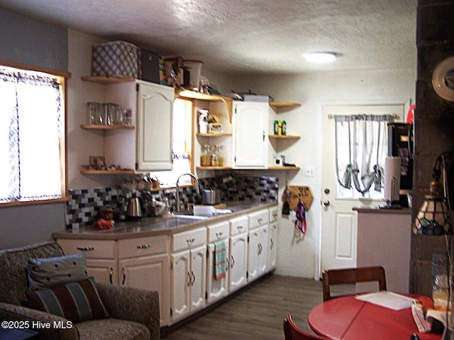 206 Community Rd, Eagle Springs, NC 27242 - kitchen featuring open shelves, dark wood-style floors, white cabinetry, healthy amount of natural light, and a textured ceiling