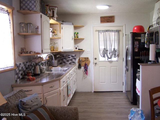 206 Community Rd, Eagle Springs, NC 27242 - kitchen with open shelves, plenty of natural light, wood finished floors, and white cabinets