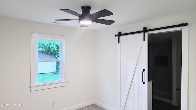 702A Richardson St # A, Elizabeth City, NC 27909 - unfurnished bedroom featuring a barn door and ceiling fan