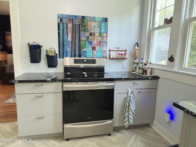 124 W Main St, Woodland, NC 27897 - kitchen featuring stainless steel electric range, dark stone counters, and white cabinets