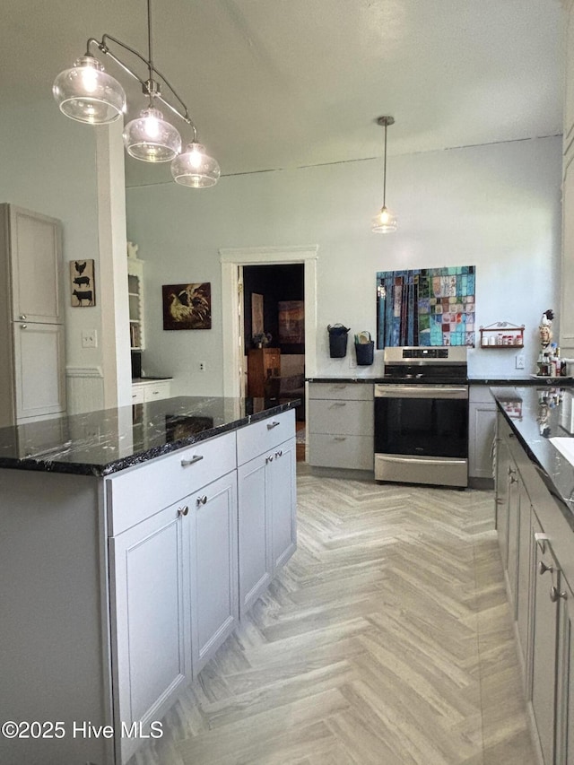 124 W Main St, Woodland, NC 27897 - kitchen featuring stainless steel electric range oven, dark stone countertops, decorative light fixtures, and a kitchen island
