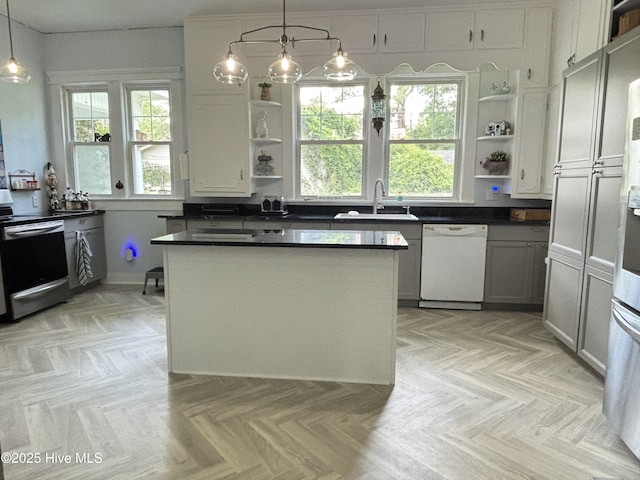 124 W Main St, Woodland, NC 27897 - kitchen with white dishwasher, open shelves, electric range, dark countertops, and a kitchen island