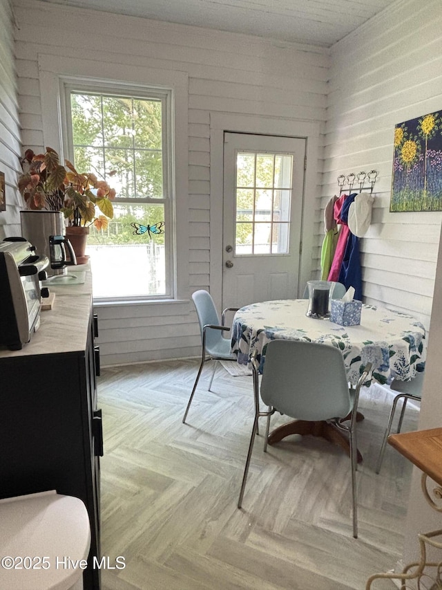 124 W Main St, Woodland, NC 27897 - dining space with healthy amount of natural light and wood walls