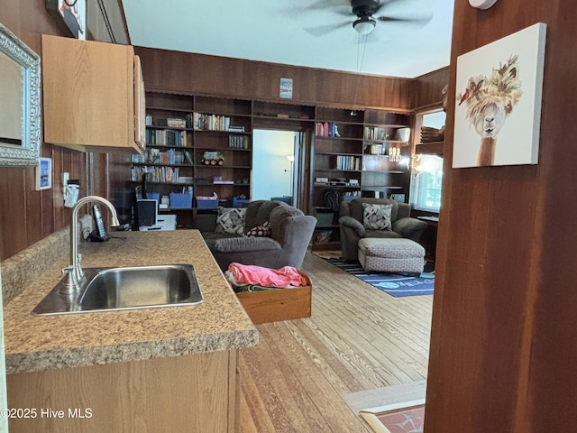 124 W Main St, Woodland, NC 27897 - kitchen with wooden walls, ceiling fan, wood finished floors, and light countertops