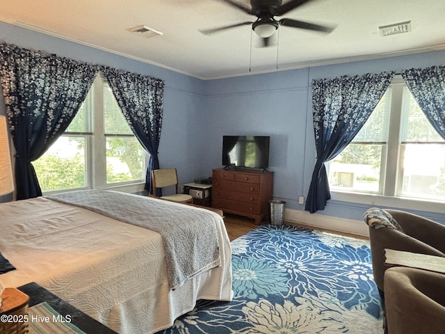124 W Main St, Woodland, NC 27897 - bedroom with ornamental molding, multiple windows, wood finished floors, and a ceiling fan