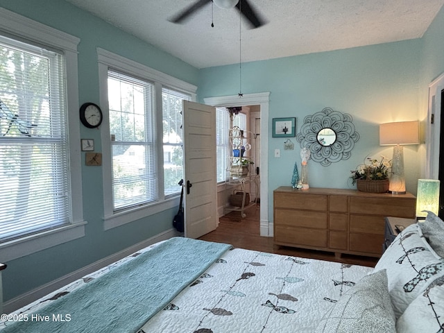 124 W Main St, Woodland, NC 27897 - bedroom with a ceiling fan, wood finished floors, and a textured ceiling