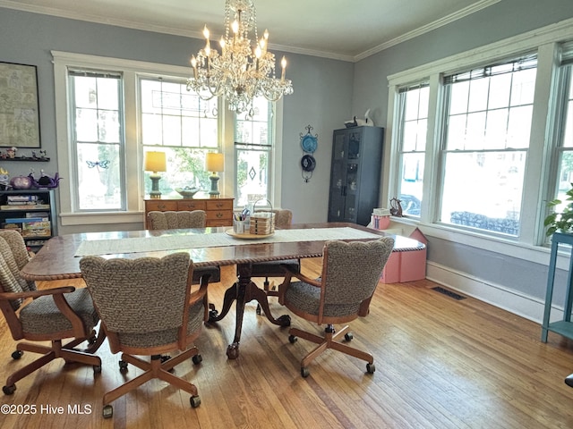 124 W Main St, Woodland, NC 27897 - dining space with wood finished floors, a chandelier, and crown molding