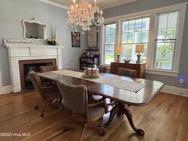 124 W Main St, Woodland, NC 27897 - dining room featuring ornamental molding, a brick fireplace, hardwood / wood-style floors, and a chandelier