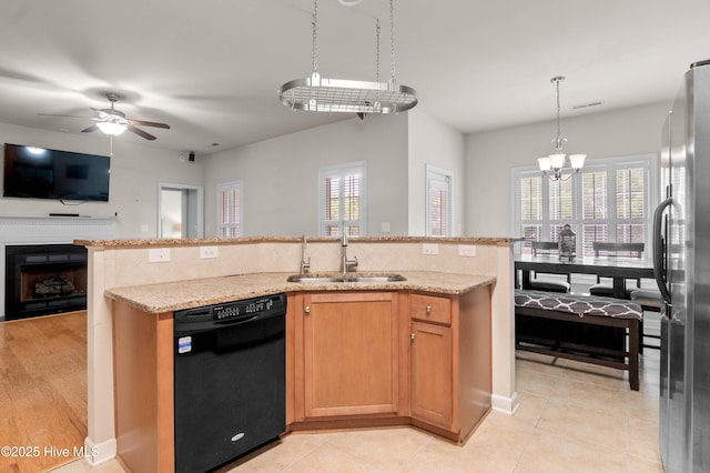213 Wynbrookee Ln, Jacksonville, NC 28546 - kitchen featuring black dishwasher, freestanding refrigerator, open floor plan, decorative backsplash, and a ceiling fan