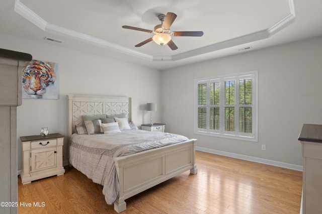 213 Wynbrookee Ln, Jacksonville, NC 28546 - bedroom with a tray ceiling, crown molding, light wood-style flooring, and ceiling fan