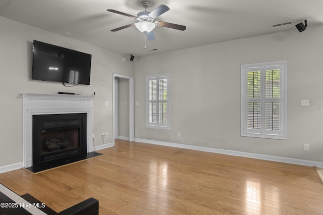 213 Wynbrookee Ln, Jacksonville, NC 28546 - unfurnished living room with a ceiling fan, hardwood / wood-style flooring, and a fireplace with flush hearth